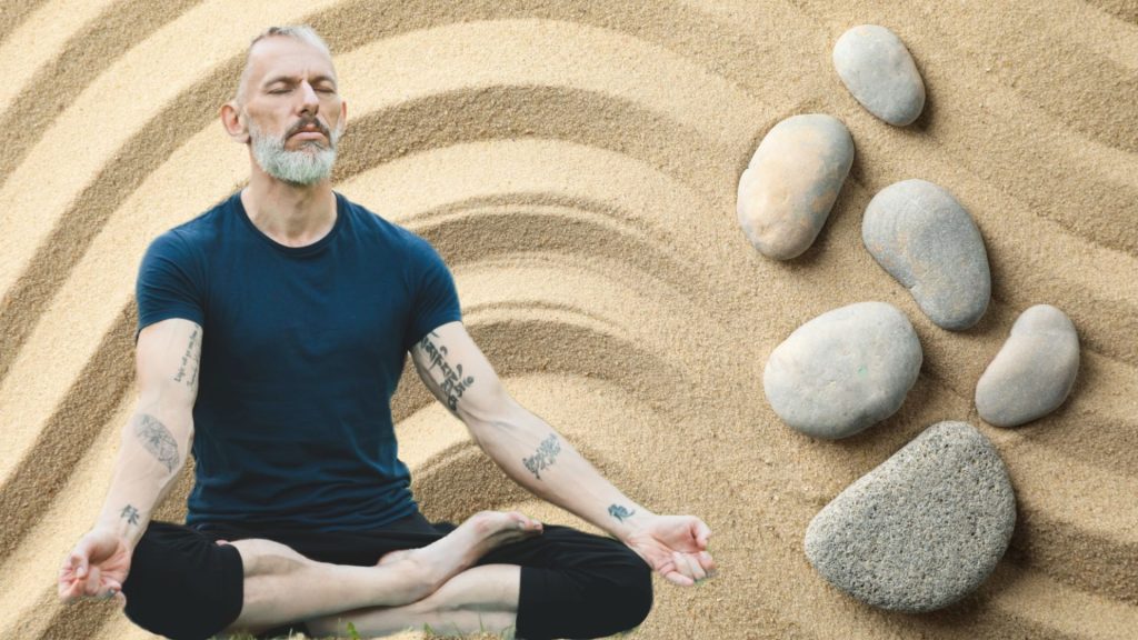 Man in deep meditation next to stones