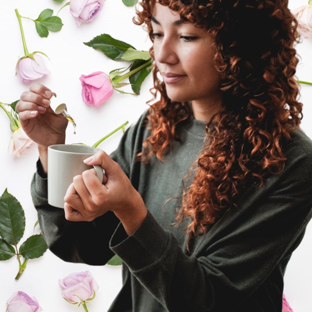 Woman adding CBD drops to coffee drink